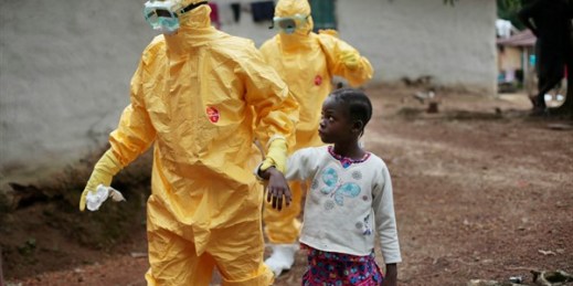 A young girl is taken to an ambulance after showing signs of Ebola in the village of Freeman Reserve, north of Monrovia, Liberia, Sept. 30, 2014 (AP photo by Jerome Delay).