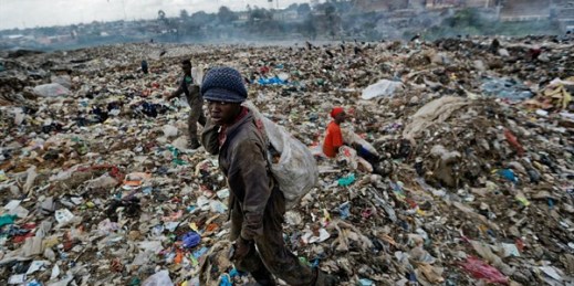 A man scavenges for pieces of plastic at a dump in the Dandora slum of Nairobi, Kenya, Dec. 5, 2018 (AP photo by Ben Curtis).