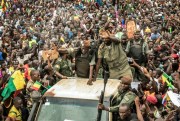 Members of the junta wave from a military vehicle as Malians celebrate the recent overthrow of President Ibrahim Boubacar Keita, in Bamako, Mali, Aug. 21, 2020 (AP photo).