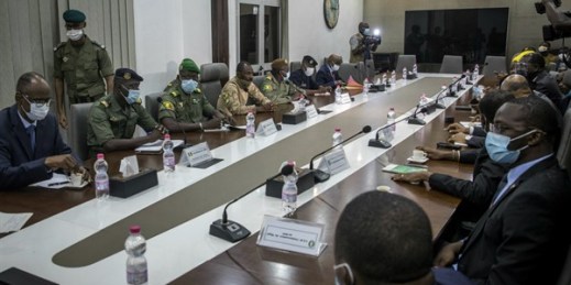 Mali’s coup leaders, left of table, meet with a high-level delegation from the West African regional bloc known as ECOWAS, in Bamako, Mali, Aug. 22, 2020 (AP photo).