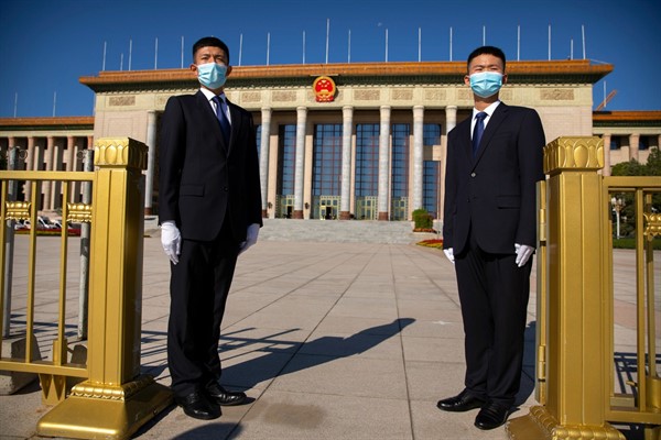 Security officials stand guard outside the Great Hall of the People before an event to honor some of those involved in China’s fight against COVID-19, in Beijing, Sept. 8, 2020 (AP photo by Mark Schiefelbein).