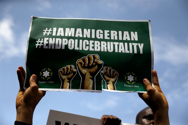 People hold banners as they demonstrate on the street to protest against police brutality in Lagos, Nigeria, Oct. 15, 2020 (AP photo by Sunday Alamba).