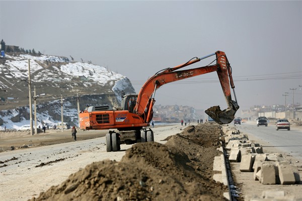 An excavator works on a road construction project in Kabul, Afghanistan, Feb. 10, 2020 (AP photo by Rahmat Gul).