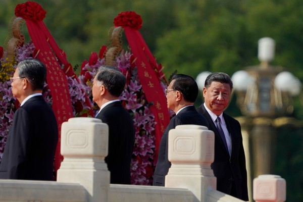 Chinese leader Xi Jinping, right, walks near the Monument to the People’s Heroes during a ceremony to mark Martyr’s Day at Tiananmen Square in Beijing, Sept. 30, 2020 (AP photo by Ng Han Guan).