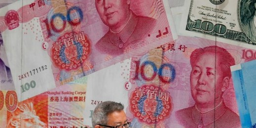 A man walks by a money exchange shop decorated with Chinese yuan banknotes and other countries currency banknotes, in Hong Kong, Aug. 6, 2019 (AP photo by Kin Cheung).