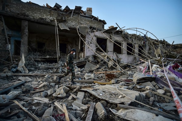 A soldier walks among debris from destroyed houses in Ganja, Azerbaijan, Oct. 17, 2020 (AP photo).