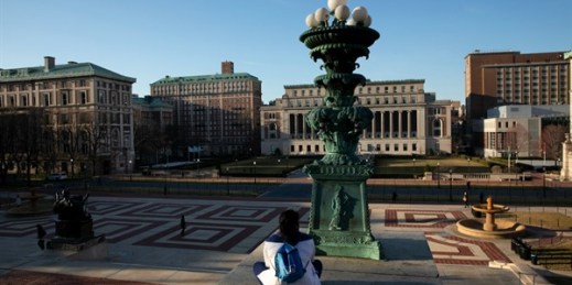 A woman sits overlooking Columbia University’s nearly empty campus, in New York, March 9, 2020 (AP photo by Mark Lennihan).
