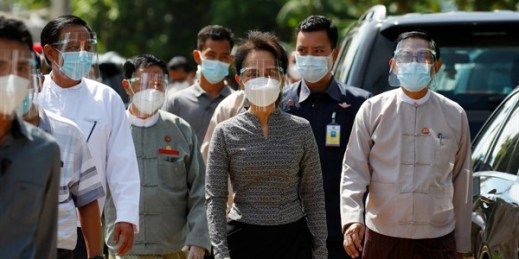 Aung San Suu Kyi, center, leaves a demonstration of voting for the upcoming  elections, in Naypyitaw, Myanmar, Oct. 20, 2020 (AP photo by Aung Shine).