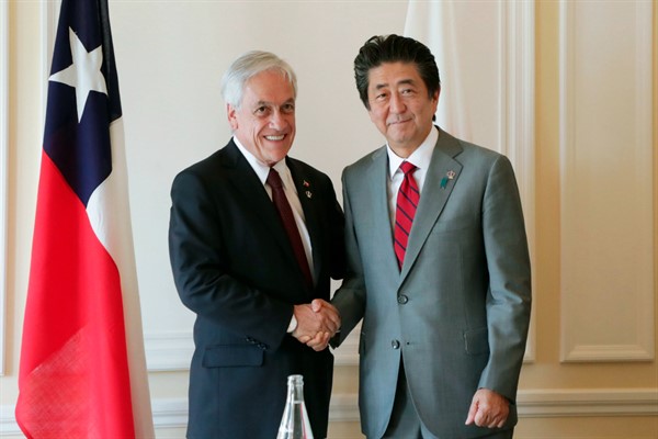 Japan’s then-prime minister, Abe Shinzo, and Chilean President Sebastian Pinera meet on the sidelines of the G-7 summit in Biarritz, France, Aug. 25, 2019 (Kyodo photo via AP).