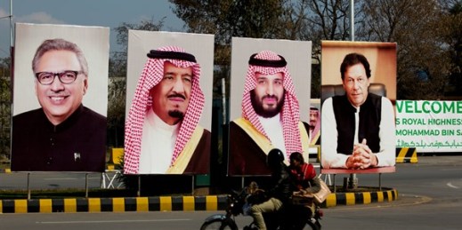 A motorcycle rides past portraits of Pakistani and Saudi leaders on display in Islamabad, Pakistan, Feb. 15, 2019 (AP photo by B.K. Bangash). Saudi-Pakistan relations, historically close, have recently hit a snag.