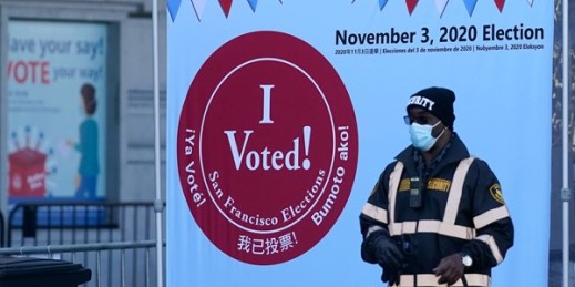 A security guard stands outside a voting center in San Francisco, Oct. 20, 2020 (AP photo by Jeff Chiu).