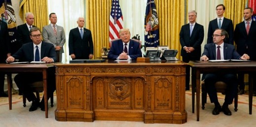 President Donald Trump participates in a signing ceremony with Serbian President Aleksandar Vucic, seated left, and Kosovar Prime Minister Avdullah Hoti, seated right, at the White House, Washington, Sept. 4, 2020 (AP photo by Evan Vucci).