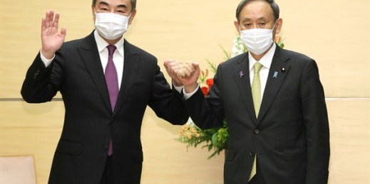Japanese Prime Minister Suga Yoshihide, right, and Chinese Foreign Minister Wang Yi in Tokyo, Japan, Nov. 25, 2020 (Photo by Masanori Genko for The Yomiuri Shimbun via AP Images).