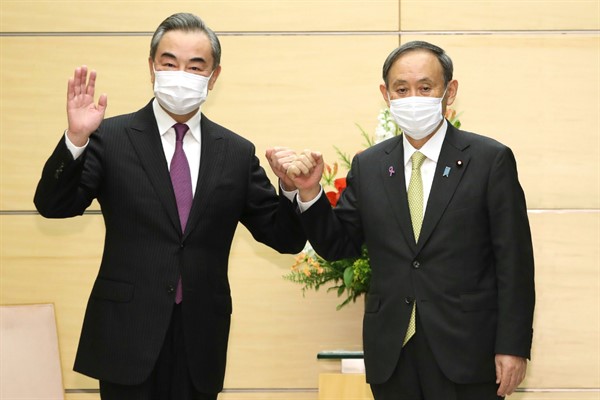 Japanese Prime Minister Suga Yoshihide, right, and Chinese Foreign Minister Wang Yi in Tokyo, Japan, Nov. 25, 2020 (Photo by Masanori Genko for The Yomiuri Shimbun via AP Images).