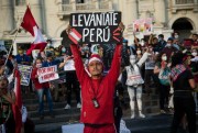 A protester holds a sign that reads in Spanish, “Wake up Peru,” during a protest to demand social changes and a new constitution from the government of new interim President Francisco Sagasti, in Lima, Peru, Nov. 21, 2020 (AP photo by Rodrigo Abd).