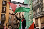 A protester waves the Sahrawi flag during a demonstration in front of the Spanish Ministry of Foreign Affairs, Madrid, Dec. 10, 2020 (Photo by Diego Radames for Sipa via AP Images).