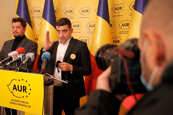 George Simion, right, and Claudiu Tarziu, the leaders of the far-right Alliance for Romanian Unity, in Bucharest, Romania, Dec. 7, 2020 (AP photo by Vadim Ghirda).