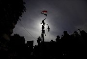 An Egyptian protester waves the national flag during a demonstration in Tahrir Square, Cairo, Egypt, Feb. 3, 2012 (AP photo by Nathalie Bardou).