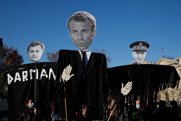 Demonstrators hold effigies of French Interior Minister Gerald Darmanin, French President Emmanuel Macron and Paris police prefect Didier Lallement during a demonstration in Paris, Nov. 28, 2020 (AP photo by Francois Mori).