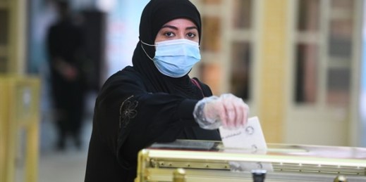 A woman casts her vote for parliamentary elections in the town of Hawally, Kuwait, Dec. 5, 2020 (AP photo by Jaber Abdulkhaleg).