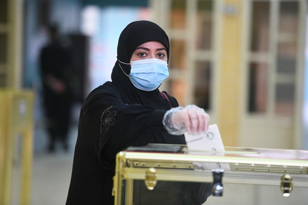 A woman casts her vote for parliamentary elections in the town of Hawally, Kuwait, Dec. 5, 2020 (AP photo by Jaber Abdulkhaleg).