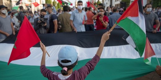 A young girl waves a Moroccan and a Palestinian flag during a protest against normalizing relations with Israel, in Rabat, Morocco, Sept. 18, 2020 (AP photo by Mosa’ab Elshamy).