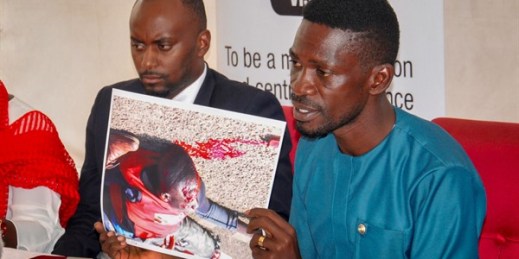 Ugandan presidential candidate Bobi Wine shows a photograph depicting a victim of recent electoral violence, at the Electoral Commission in Kampala, Uganda, Dec. 2, 2020 (AP photo by Ronald Kabuubi).