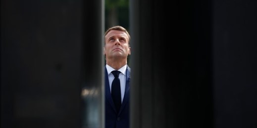 French President Emmanuel Macron looks up at a statue of Gen. Charles de Gaulle during a ceremony to mark the 75th anniversary of the end of World War II in Europe, in Paris, May 8, 2020 (AP photo by Francois Mori).