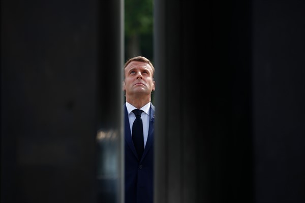 French President Emmanuel Macron looks up at a statue of Gen. Charles de Gaulle during a ceremony to mark the 75th anniversary of the end of World War II in Europe, in Paris, May 8, 2020 (AP photo by Francois Mori).