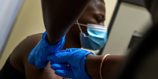 A volunteer for a COVID-19 vaccine trial receives her second shot at a hospital outside Johannesburg, South Africa, Nov. 30, 2020 (AP photo by Jerome Delay).