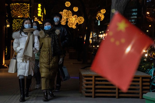 People wearing masks on New Year’s Eve in Beijing, Dec. 31, 2020 (AP photo by Ng Han Guan).
