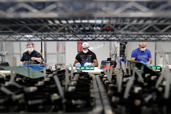 Ford Motor Company line workers assemble ventilators at the Ford Rawsonville plant in Ypsilanti Township, Michigan, May 13, 2020 (AP photo by Carlos Osorio).