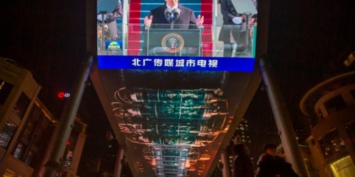 A large video screen shows a government news report about the inauguration of President Joe Biden at a shopping mall in Beijing, Jan. 21, 2021 (AP photo by Mark Schiefelbein).