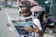 A man reads a newspaper reacting to the news of Joe Biden’s victory in the U.S. presidential election, in Lagos, Nigeria, Nov. 8, 2020 (AP photo by Sunday Alamba).