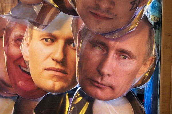 Masks depicting Russian President Vladimir Putin, right, and Russian opposition leader Alexei Navalny, left of Putin, at a street souvenir shop in St. Petersburg, Russia, Jan. 17, 2021 (AP photo by Dmitri Lovetsky).