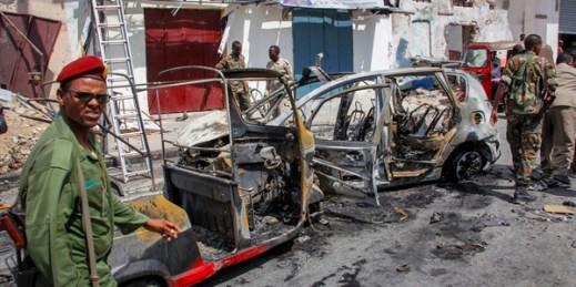 Security forces examine the wreckage of vehicles after a bomb attack near the presidential palace, in Mogadishu, Somalia, Jan. 8, 2020 (AP photo by Farah Abdi Warsameh).