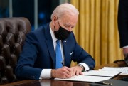 President Joe Biden signs an executive order on immigration at the White House, Washington, Feb. 2, 2021 (AP photo by Evan Vucci).