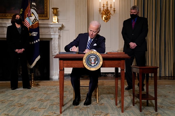 President Joe Biden signs an executive order on climate change in the State Dining Room of the White House, in Washington, Jan. 27, 2021 (AP photo by Evan Vucci).