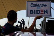 A woman holds up a sign that reads, in Spanish, “Cubans with Biden,” as then-Democratic presidential candidate Joe Biden speaks in Miramar, Florida, Oct. 13, 2020 (AP photo by Carolyn Kaster).