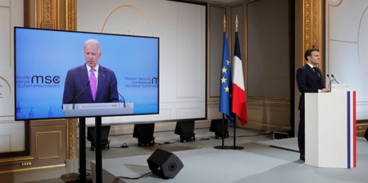 French President Emmanuel Macron, right, attends a videoconference meeting as U.S. President Joe Biden appears on a screen, Paris, Feb. 19, 2021 (pool photo by Benoit Tessier via AP Images).