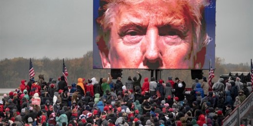 Supporters of President Donald Trump watch a video during a campaign event in Lansing, Mich., Oct. 27, 2020 (Photo by Nicole Hester for Mlive.com and Ann Arbor News, via AP)