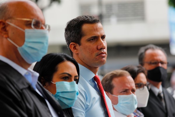 Juan Guaido, center, with other opposition party members at a press conference in Caracas, Venezuela, Dec. 7, 2020 (AP photo by Ariana Cubillos).