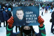 A man holds a poster in support of Russian opposition leader Alexei Navalny.