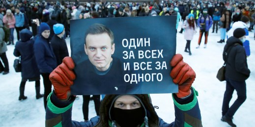 A man holds a poster in support of Russian opposition leader Alexei Navalny.