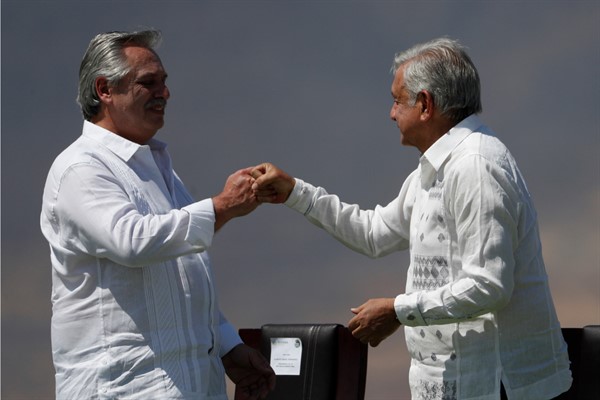 Mexican President Andres Manuel Lopez Obrador, right, and Argentine President Alberto Fernandez during a ceremony marking Flag Day in Iguala, Mexico, Feb. 24, 2021 (AP photo by Eduardo Verdugo).