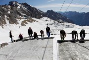 Workers cover a glacier with oversized plastic sheets meant to keep it from melting during the summer months, on the peak of Germany’s highest mountain, Zugspitze, near Garmisch-Partenkirchen, May 10, 2011 (AP photo by Matthias Schrader).