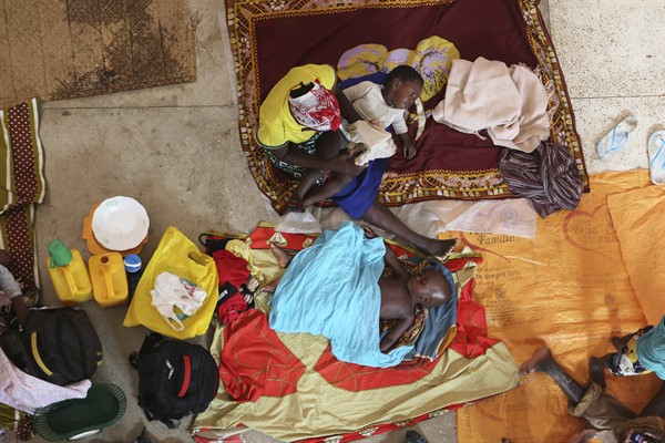 A displaced mother and her children prepare for the night inside a church in Pemba city, Cabo Delgado province, Mozambique, April 19, 2019 (AP photo by Tsvangirayi Mukwazhi).