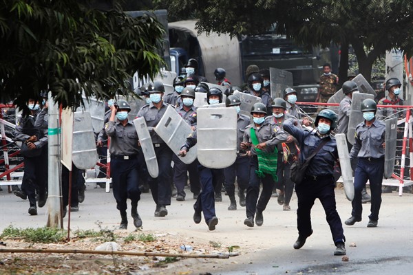 Police charge forward to disperse protesters in Mandalay, Myanmar, Feb. 20, 2021 (AP Photos).