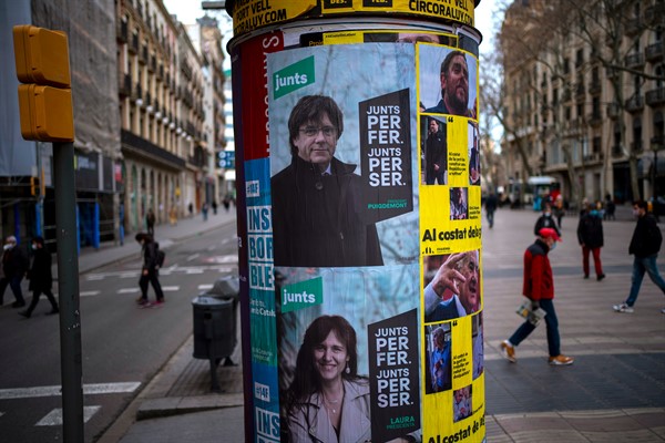 Posters show candidates for Catalonia’s regional election, in Barcelona, Spain, Feb. 9, 2021 (AP photo by Emilio Morenatti).