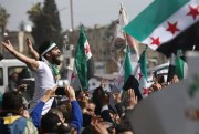 Anti-Syrian government protesters mark 10 years since the start of a popular uprising against President Bashar al-Assad’s rule in Idlib, Syria, March 15, 2021 (AP photo by Ghaith Alsayed).